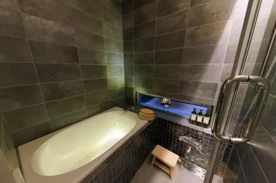 a bathroom with a bath tub and a sink at TokyoKoso Vacation Home in Tokyo
