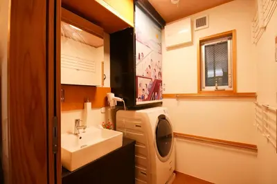 a bathroom with a sink and a washing machine at TokyoKoso Vacation Home in Tokyo