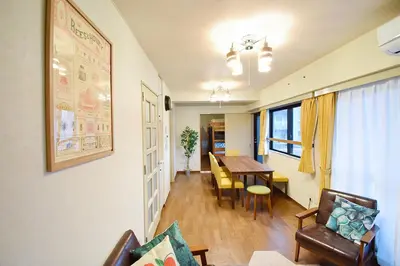 a living room with a table and a dining room at Hostel Inn Tokyo Ryogoku in Tokyo