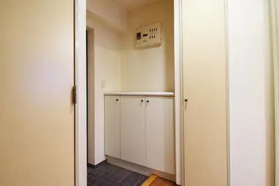 a small room with a white cabinet and a door at Hostel Inn Tokyo Ryogoku in Tokyo