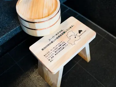 a wooden stool with a sign on top of it at Super Hotel Shinagawa Shinbanba in Tokyo