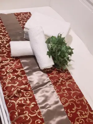 a table with towels and a plant on it at \u7f8e\u30cf\u30a6\u30b9 Beauty House in Tokyo