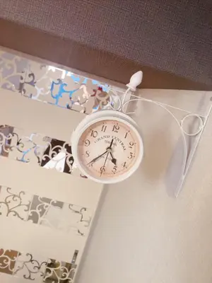 a clock hanging on a wall next to a shelf at \u7f8e\u30cf\u30a6\u30b9 Beauty House in Tokyo