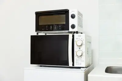 a microwave oven sitting on top of a counter at ROMANTIC FLAT IN THE HEART OF SHIBUYA / 7MIN WALK in Tokyo