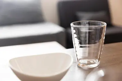 a glass of water next to a plate on a table at ROMANTIC FLAT IN THE HEART OF SHIBUYA / 7MIN WALK in Tokyo