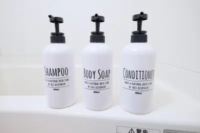 four white bottles of laundry detergent on a shelf at \u5922\u306e\u820e \u6d45\u8349 Yumenoya Asakusa in Tokyo