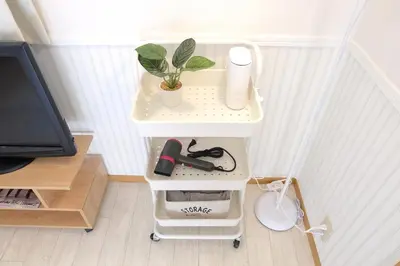 a small white shelf with a plant on it at \u5922\u306e\u820e \u6d45\u8349 Yumenoya Asakusa in Tokyo