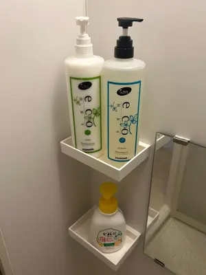 two bottles of soap and moisturizers on shelves in a bathroom at Tokyo Skytree Home Skytree View Hikifune in Tokyo