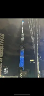 a tower lit up in blue lights in a city at Tokyo Skytree Home Skytree View Hikifune in Tokyo