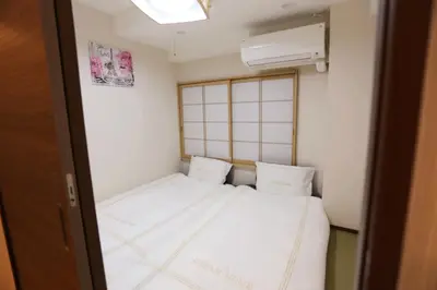 a small room with a white bed and a window at Shinjuku private homestay max 10ppl in Tokyo