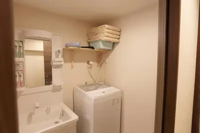 a bathroom with a washing machine and a sink at Shinjuku private homestay max 10ppl in Tokyo