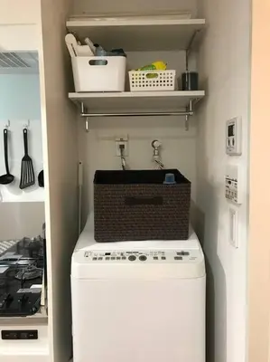 a washing machine with a basket on top of it at Shinagawa New Apt Easy access to both Haneda & Narita Airport in Tokyo