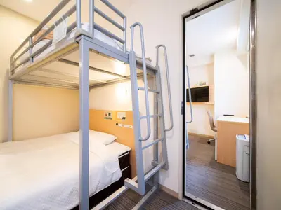 a room with a bunk bed and a bathroom at Super Hotel Asakusa in Tokyo