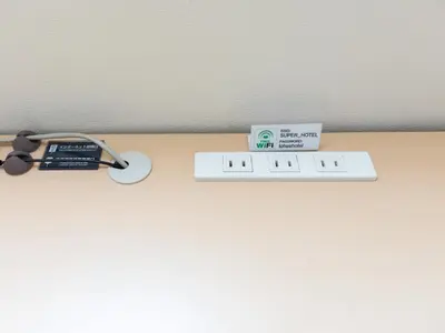 a shelf with a thermometer and glasses on a table at Super Hotel Asakusa in Tokyo