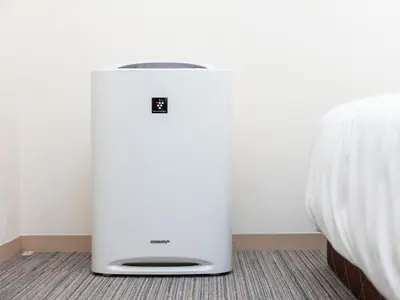 a white refrigerator in a room next to a bed at Super Hotel Asakusa in Tokyo