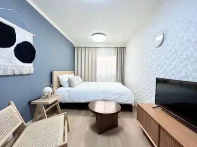 a bedroom with a bed and a flat screen tv at Tranquil house with 3 bedrooms 7min to metro straight to Shinjuku and Shibuya in Tokyo