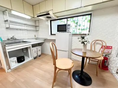 a small kitchen with a table and chairs and a sink at Tranquil house with 3 bedrooms 7min to metro straight to Shinjuku and Shibuya in Tokyo