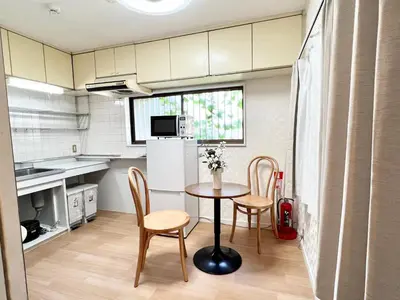 a kitchen with a table and chairs in a room at Tranquil house with 3 bedrooms 7min to metro straight to Shinjuku and Shibuya in Tokyo