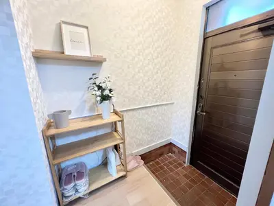 a hallway with a door and a shelf with shoes at Tranquil house with 3 bedrooms 7min to metro straight to Shinjuku and Shibuya in Tokyo
