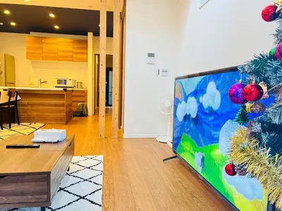a living room with a large flat screen tv at Zaki-House-EG0307 in Tokyo