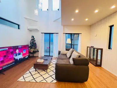 a living room with a couch and a tv at Zaki-House-EG0307 in Tokyo