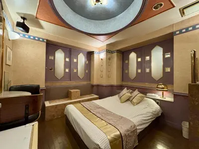 a bedroom with a large bed and a bath room at Hotel Crystal -\u5927\u4eba\u5c02\u7528-- in Tokyo