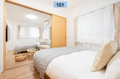 a bedroom with a bed and a large mirror at Shinjuku area/Family-apartment/4 min to Subway in Tokyo