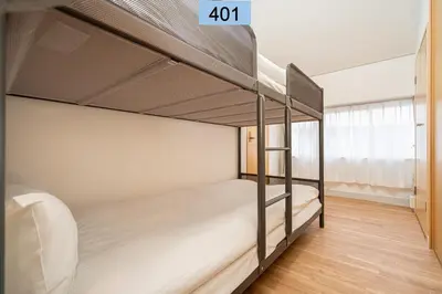 a bedroom with two bunk beds and a window at Shinjuku area/Family-apartment/4 min to Subway in Tokyo