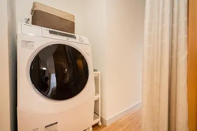 a washing machine in a room with a curtain at Shinjuku area/Family-apartment/4 min to Subway in Tokyo