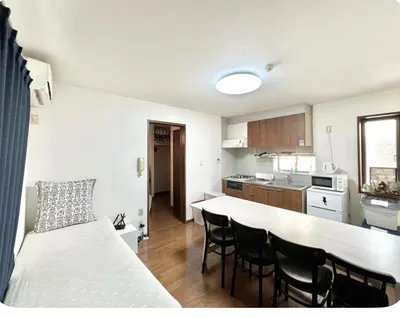 a kitchen with a table and chairs in a room at \u76f4\u8fbe-\u6c60\u888b-2\u5206\u949f \u8f66\u7ad9\u5f92\u6b656\u5206\u949f 3bedrooms-IT0338 in Tokyo