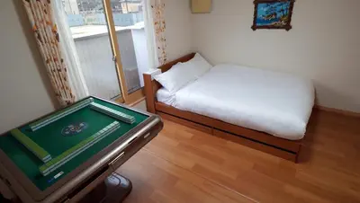 a small room with a bed and a pool table at \u6771\u8cc0\u65c5\u9928 in Tokyo