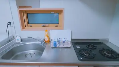 a kitchen counter with a sink and a stove at \u6771\u8cc0\u65c5\u9928 in Tokyo