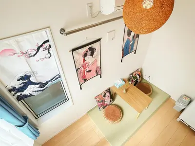 a room with paintings on the walls and a table at Koenji loft apartment/Shinjuku&Kichijoji/JR in Tokyo