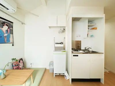 a small kitchen with white cabinets and a sink at Koenji loft apartment/Shinjuku&Kichijoji/JR in Tokyo