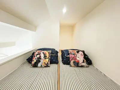 two bags sitting on a bed in a room at Koenji loft apartment/Shinjuku&Kichijoji/JR in Tokyo