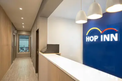 an office lobby with a hop inn sign on the wall at Hop Inn Tokyo Iidabashi in Tokyo