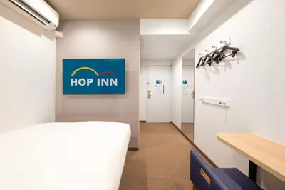 a hospital room with a hop inn sign on the wall at Hop Inn Tokyo Iidabashi in Tokyo