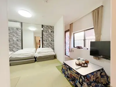 a living room with two beds and a tv at Hananosato Akabane - Vacation STAY 06096v in Tokyo