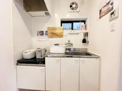 a small kitchen with white cabinets and a sink at Hananosato Akabane - Vacation STAY 06096v in Tokyo