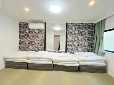 a living room with a large couch in front of a mirror at Hananosato Akabane - Vacation STAY 06136v in Tokyo