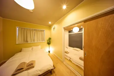 a bedroom with a large white bed and a mirror at futaba heights - Vacation STAY 15532 in Tokyo