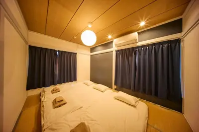 a bedroom with a large white bed in front of a window at futaba heights - Vacation STAY 15532 in Tokyo