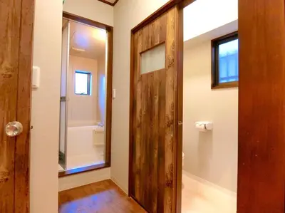 a bathroom with a wooden door and a tub at futaba heights - Vacation STAY 15533 in Tokyo