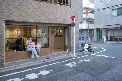 a woman and child sitting in a store window at \u30ea\u30a2\u30eb\u9326\u7cf8101 in Tokyo