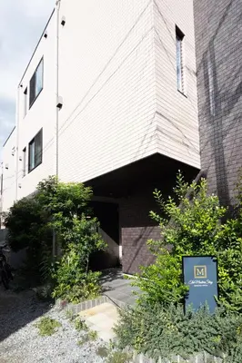 a building with a nissan sign in front of it at “1ST ROOM” 内装デザイナー監修！30㎡ 最大6名 経堂駅から徒歩5分 築浅 良質な暮らしを in Tokyo