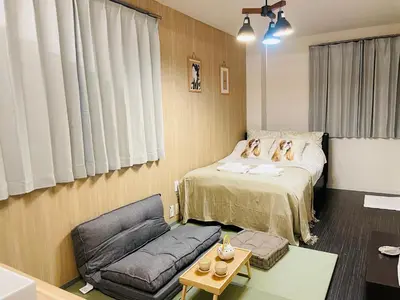 two dogs sitting on a bed in a room at Sky house\u6674\u7a7a\u58543 in Tokyo