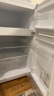 an empty refrigerator with its door open in a kitchen at Sky house\u6674\u7a7a\u5854106 in Tokyo