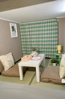 a living room with a table and a couch at Sky house \u6674\u7a7a\u585413 in Tokyo