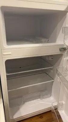 a white refrigerator with its door open with its empty shelves at Sky house \u6674\u7a7a\u585413 in Tokyo