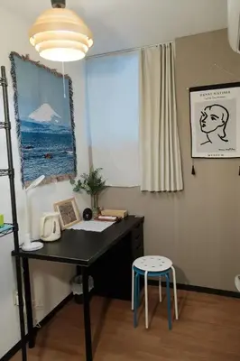 a desk with a phone and a chair in a room at Sky \u6674\u7a7a\u5854 \u72ec\u7acb\u53cc\u4eba\u95f4 \u4f46\u662f\u5171\u7528\u6d74\u5ba4\u5395\u6240105 in Tokyo